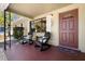 Charming front porch with two rocking chairs and a small table perfect for relaxing with a cool drink at 138 Edgewater Ter, Dunedin, FL 34698