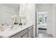 Bathroom featuring double sinks, a large mirror, and an open doorway to the bedroom at 17468 Whiskey Creek Trl, Parrish, FL 34219