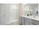 Well-lit bathroom with double sinks, spacious vanity, and a shower with a curtain at 17468 Whiskey Creek Trl, Parrish, FL 34219