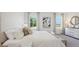 Comfortable bedroom with a large bed, natural light, a bench, and a dresser at 17468 Whiskey Creek Trl, Parrish, FL 34219