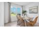 Charming dining room with a large window, a stylish table and wicker chairs at 17468 Whiskey Creek Trl, Parrish, FL 34219