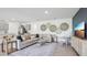 Spacious living room and kitchen with modern sofa, stylish decor and island with seating at 17468 Whiskey Creek Trl, Parrish, FL 34219