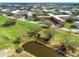 An aerial view of the community and surrounding landscape, including a pond and golf course at 2403 Finlandia Ln # 27, Clearwater, FL 33763