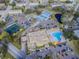 Aerial shot showcasing the complex with a pool, tennis courts, shuffleboard court, parking and green space at 2403 Finlandia Ln # 27, Clearwater, FL 33763