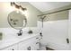 Bright bathroom features a bathtub, modern vanity, and round mirror with a black frame at 2403 Finlandia Ln # 27, Clearwater, FL 33763