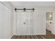 A view of the custom sliding barn doors from the bedroom to another room at 2403 Finlandia Ln # 27, Clearwater, FL 33763