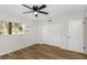 The bedroom features vinyl plank flooring, a ceiling fan, and a large window at 2403 Finlandia Ln # 27, Clearwater, FL 33763
