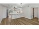 Open concept dining room featuring wood floors and eat-in breakfast bar at 2403 Finlandia Ln # 27, Clearwater, FL 33763