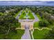 Stunning aerial view of the community entrance, featuring a manicured landscape and beautiful water feature at 2403 Finlandia Ln # 27, Clearwater, FL 33763