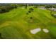 Expansive aerial view of a meticulously maintained golf course with lush greens and sand traps at 2403 Finlandia Ln # 27, Clearwater, FL 33763