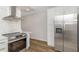 Modern kitchen with stainless steel appliances and wood grain floors at 2403 Finlandia Ln # 27, Clearwater, FL 33763