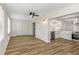 Open concept floor plan showcasing bright living room with an eat-in kitchen and wood flooring at 2403 Finlandia Ln # 27, Clearwater, FL 33763