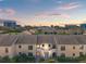 Sunset aerial view of multi-Gathering townhomes showcasing the neighborhood landscape at 2462 Kingfisher Ln # J203, Clearwater, FL 33762