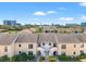 An aerial view of the townhome community, highlighting the surrounding neighborhood and nearby cityscape at 2462 Kingfisher Ln # J203, Clearwater, FL 33762