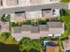 Overhead view of townhomes with landscaped walkways, driveways, and green spaces at 2462 Kingfisher Ln # J203, Clearwater, FL 33762