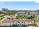 Scenic aerial view of townhomes with a beautiful pond and cityscape backdrop at 2462 Kingfisher Ln # J203, Clearwater, FL 33762