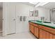 Bright bathroom featuring double sinks, wood vanity, and ample space at 2462 Kingfisher Ln # J203, Clearwater, FL 33762