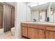 Bathroom featuring a wood vanity, a sink, and a shower with gray curtain at 2462 Kingfisher Ln # J203, Clearwater, FL 33762