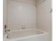 A tiled bathtub features a shower head and faucet with tiled walls at 2462 Kingfisher Ln # J203, Clearwater, FL 33762