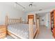 Cozy bedroom featuring a wooden bed frame, ceiling fan, and bright lighting at 2462 Kingfisher Ln # J203, Clearwater, FL 33762