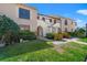 Charming townhome featuring landscaped front yard and classic architectural details at 2462 Kingfisher Ln # J203, Clearwater, FL 33762