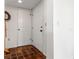 A view of the foyer with tile flooring, coat rack and access to storage at 2462 Kingfisher Ln # J203, Clearwater, FL 33762