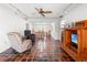 Bright living room featuring tile flooring, ceiling fan, and an open floor plan at 2462 Kingfisher Ln # J203, Clearwater, FL 33762