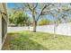 Backyard featuring a large grassy area, mature trees, and a privacy fence, perfect for outdoor enjoyment at 25325 Welsh Poppy Way, Land O Lakes, FL 34639