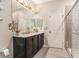 Bathroom featuring double sinks, granite countertops, and a glass-enclosed shower at 25325 Welsh Poppy Way, Land O Lakes, FL 34639