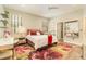 Cozy bedroom featuring a floral rug and a stylish vanity table at 25325 Welsh Poppy Way, Land O Lakes, FL 34639