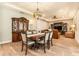 Formal dining room features an ornate hutch, wood floors, and an elegant chandelier at 25325 Welsh Poppy Way, Land O Lakes, FL 34639