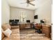 Flex room features multiple work stations, comfortable couch and natural light at 25325 Welsh Poppy Way, Land O Lakes, FL 34639