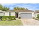 Charming single-story home featuring a well-maintained lawn, brick driveway, and a neutral color scheme at 25325 Welsh Poppy Way, Land O Lakes, FL 34639