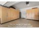 Two car garage w/ upgraded epoxy flooring and custom storage at 25325 Welsh Poppy Way, Land O Lakes, FL 34639