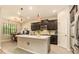 Bright kitchen with a large island, pendant lighting, stainless steel appliances, and ample counter space at 25325 Welsh Poppy Way, Land O Lakes, FL 34639