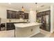 Well-equipped kitchen with granite countertops, dark cabinets and stainless steel appliances at 25325 Welsh Poppy Way, Land O Lakes, FL 34639