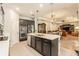 Modern kitchen with stainless steel appliances, central island, and open floor plan to the living and dining areas at 25325 Welsh Poppy Way, Land O Lakes, FL 34639