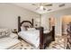 Comfortable main bedroom with a ceiling fan, ensuite bathroom, and hardwood floors at 25325 Welsh Poppy Way, Land O Lakes, FL 34639