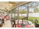 Screened patio with outdoor dining and ceiling fans overlooks the backyard at 25325 Welsh Poppy Way, Land O Lakes, FL 34639