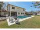 Beautiful backyard featuring a swimming pool, screened-in patio, and well-manicured lawn, perfect for relaxation at 2717 Warwick Ter, Palm Harbor, FL 34685