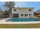 Spacious backyard featuring a large pool, covered patio, and lush green lawn, ideal for outdoor entertaining at 2717 Warwick Ter, Palm Harbor, FL 34685