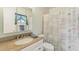 Cozy bathroom featuring a vanity with stone counters, framed mirror, toilet, and shower with curtain at 2717 Warwick Ter, Palm Harbor, FL 34685