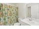 Cozy bathroom featuring a shower/tub combination, a floral shower curtain, and a vanity with a mirror at 2717 Warwick Ter, Palm Harbor, FL 34685