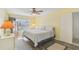 Bedroom featuring a window, closet, TV on a dresser, ceiling fan, and wood-look flooring at 2717 Warwick Ter, Palm Harbor, FL 34685