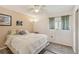 Bedroom featuring a window, dark curtains, light ceiling fan, and an area rug at 2717 Warwick Ter, Palm Harbor, FL 34685