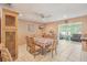 Dining area featuring tile flooring, a ceiling fan, and a view into the living room at 2717 Warwick Ter, Palm Harbor, FL 34685