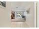Hallway leading to the living area with tile flooring and view to the backyard at 2717 Warwick Ter, Palm Harbor, FL 34685