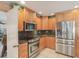 Updated kitchen featuring stainless steel appliances, granite countertops, and wood cabinetry at 2717 Warwick Ter, Palm Harbor, FL 34685