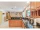 Open kitchen featuring granite countertops, stainless steel appliances, and a breakfast bar at 2717 Warwick Ter, Palm Harbor, FL 34685