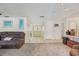 Spacious living room with carpet, tile flooring, recessed lighting, and a comfortable brown sofa at 2717 Warwick Ter, Palm Harbor, FL 34685